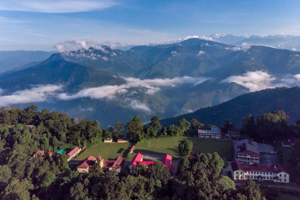 Dr Graham's Homes campus on its Himalayan ridge, snow peaks on the horizon